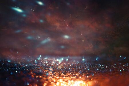 background of abstract glitter lights. gold, blue and black. de focused