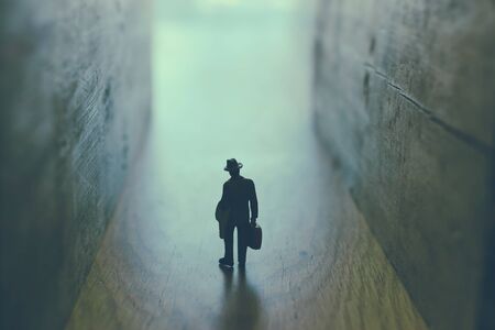 Businessman walks on an unknown roadの写真素材