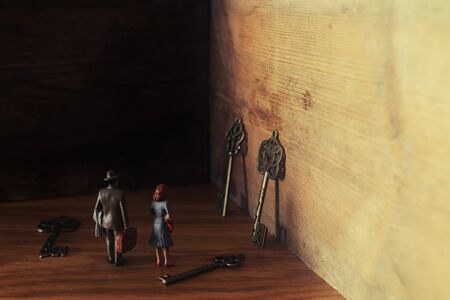 image of woman and man facinga dead end and looking for the right key. concept of gender issues and problem solvingの写真素材