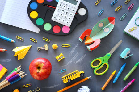 education. Back to school concept. rocket cut from paper and painted over blackboard background. top...