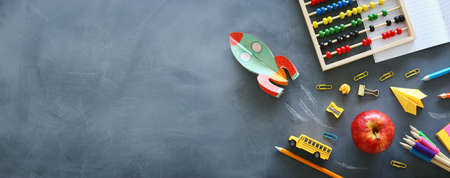 education. Back to school concept. rocket cut from paper and painted over blackboard background. top view, flat layの写真素材