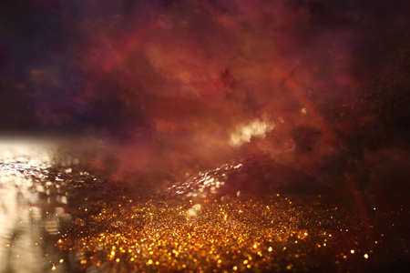 background of abstract red, gold and black glitter lights. defocusedの写真素材