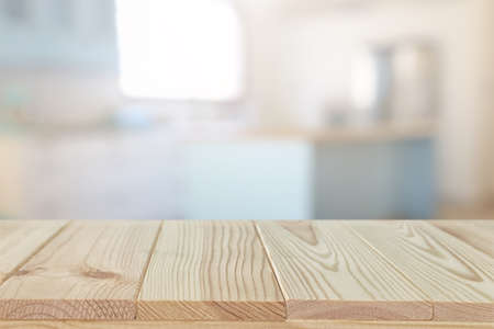 empty table board and defocused modern kitchen background. product display and picnic conceptの写真素材