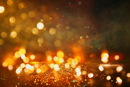 background of abstract gold and black glitter lights. defocusedの写真素材