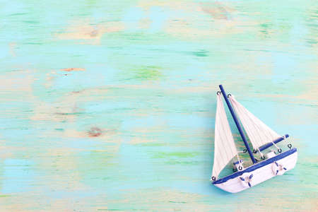 wooden vintage boat over blue backgroundの写真素材
