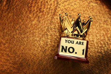 image of golden crown award over luxury brass background