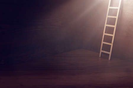 image of ladder over dark wooden wall with light. concept of hope, faith, religion and success