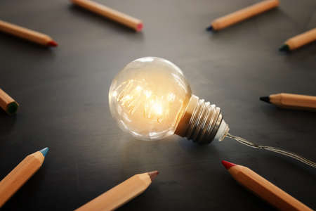Education concept image. Creative idea and innovation. Light bulb as metaphor over blackboard
