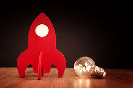 education or innovation concept. Wooden rocket over blackboard background. top viewの写真素材