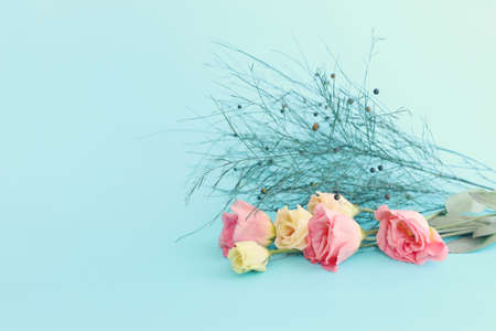 spring bouquet of pink and white flowers over pastel blue backgroundの写真素材