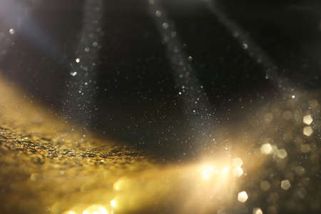 background of abstract gold and black glitter lights. defocused