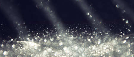 background of abstract silver and black glitter lights. defocused