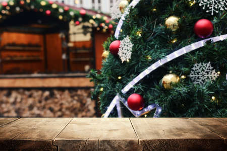 Empty table in front of christmas tree with decorations background. For product display montageの写真素材