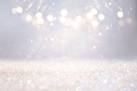 glitter vintage lights background. silver, gold and white. de-focusedの写真素材