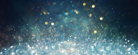 background of abstract glitter lights. silver, blue and black. de focused