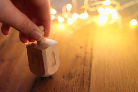 Banner of jewish holiday Hanukkah with wooden dreidels (spinning top) over wooden background