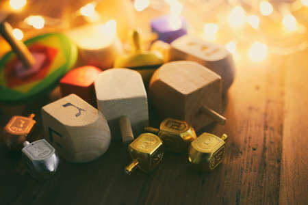 Banner of jewish holiday Hanukkah with wooden dreidels (spinning top) over wooden background