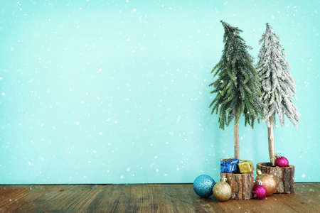 Image of christmas tree with decorations in front of pastel blue backgroundの写真素材