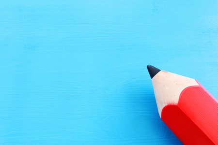 Big red pencil on blue backgroundの写真素材