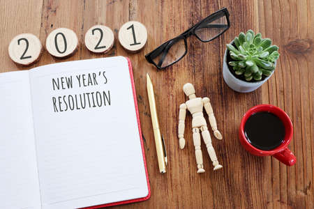 Business concept of top view 2021 goals list with notebook, cup of coffee over wooden deskの写真素材