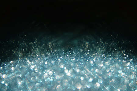 background of abstract glitter lights. silver, blue and black. de focused