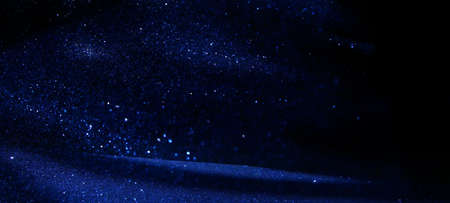 background of abstract glitter lights. silver, blue and black. de focused