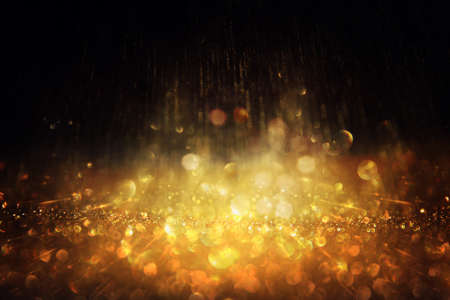 background of abstract gold and black glitter lights. defocusedの写真素材