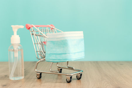 Basket or shopping cart with protective mask. Maintaining safe purchase during the COVID 19 epidemicの写真素材