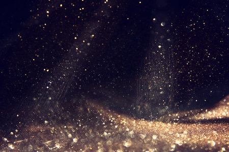 background of abstract gold and black glitter lights. defocusedの写真素材