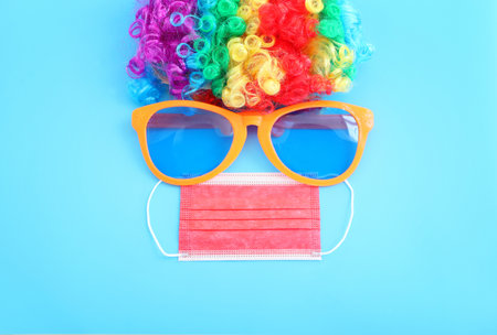 carnival, party and Purim celebration (jewish carnival holiday) over blue background. Coronavirus prevention concept, medical maskの写真素材