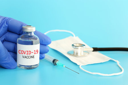 Doctor or nurse holding covid 19 vaccine. Healthcare and Medical conceptの写真素材