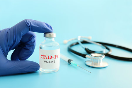 Doctor or nurse holding covid 19 vaccine. Healthcare and Medical conceptの写真素材