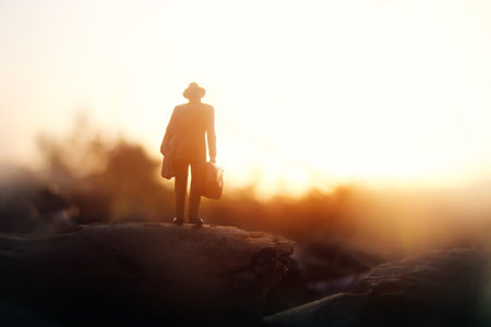 Surreal image of mysterious man walking alone during sunsetの写真素材