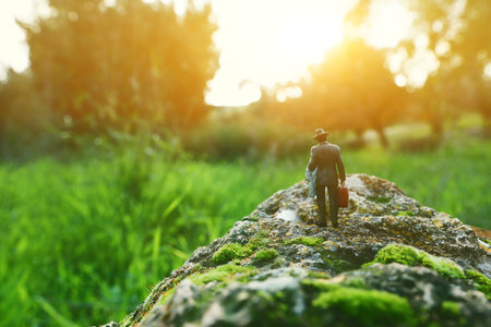 Surreal image of mysterious man walking alone in during sunsetの写真素材