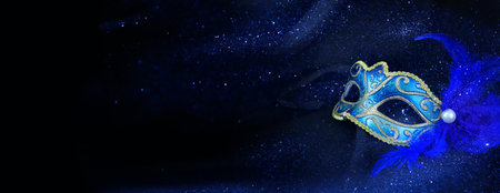 Photo of elegant and delicate Venetian mask over dark silk backgroundの写真素材