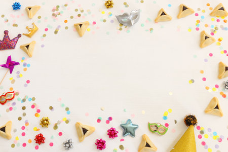 Purim celebration concept (jewish carnival holiday) over wooden white background. Top view, flat layの写真素材
