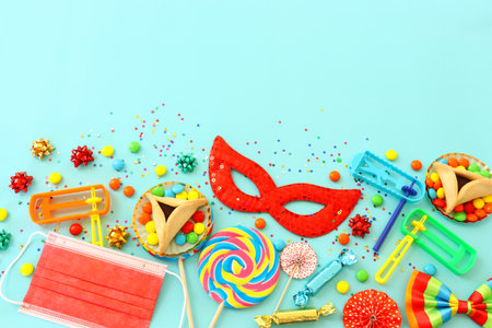 Purim celebration concept (jewish carnival holiday) over blue background. Top view, Flat lay. Coronavirus prevention concept, medical maskの写真素材