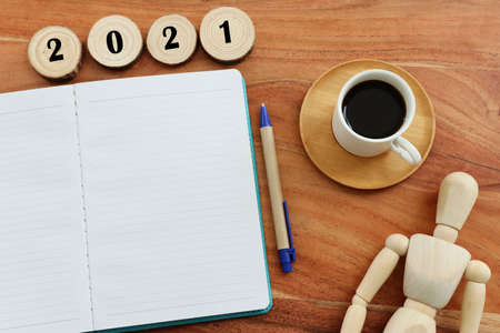 Business concept of top view 2021 with empty notebook over wooden deskの写真素材