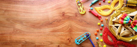 Purim celebration concept (jewish carnival holiday) over wooden background. Top view, flat layの写真素材