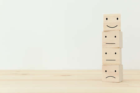 Concept image of satisfaction level. wooden cubes with emotions