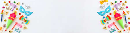 Purim celebration concept (jewish carnival holiday) over wooden white background. Top view, flat lay