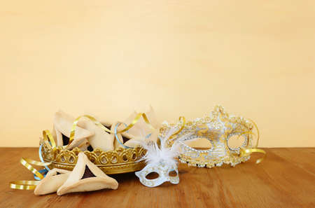 Purim celebration concept (jewish carnival holiday) over wooden tableの写真素材