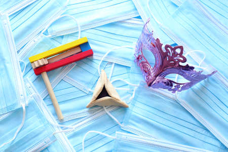 Purim celebration concept (jewish carnival holiday) over medical masks background. Top view, Flat lay. Coronavirus prevention conceptの写真素材