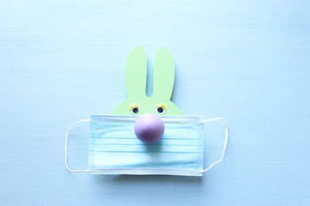 Cute bunny with medical mask. Top view, Flat lay. Coronavirus prevention conceptの写真素材