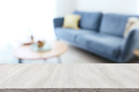 Wooden empty table in front of Living room sofa interior. For product display and presentationの写真素材