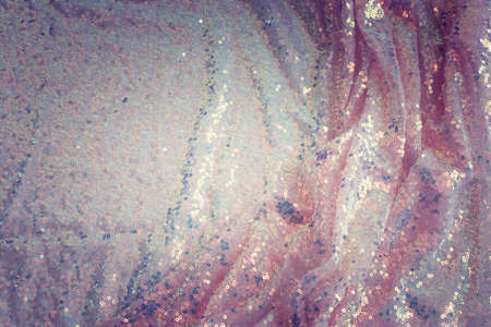 background of beautiful golden and pink sequins fabricの写真素材