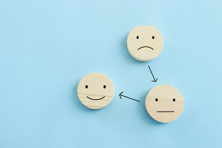 Concept image of satisfaction level. wooden cubes with emotionsの写真素材