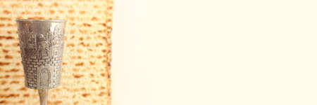 Passover background. Old Wine cup and matzoh (jewish holiday bread)