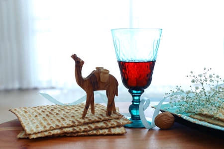 Passover background. Glass Wine cup and matzoh (jewish holiday bread)