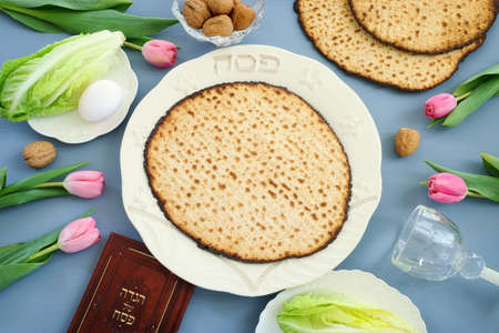 Pesah celebration concept (jewish Passover holiday). Traditional book with text in hebrew: Passover...